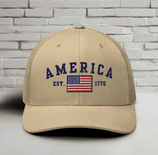 America Est. 1776 Trucker Hat – Blue Embroidery, Patriotic Cap for Proud Americans, Perfect Gift for Freedom Lovers - SKULLFURY MERCH